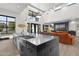 Open concept kitchen and living room showcasing hardwood floors, large island, and plenty of natural light at 1807 E Campbell Ave, Phoenix, AZ 85016