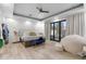 Spacious main bedroom with modern furnishings, decorative accent wall, and access to backyard at 1807 E Campbell Ave, Phoenix, AZ 85016