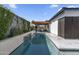 Backyard pool with a pergola-covered outdoor kitchen and lush landscaping at 1807 E Campbell Ave, Phoenix, AZ 85016