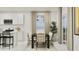 Elegant dining area with a stylish table, chairs, and a view through a large window at 20925 S 231St Way, Queen Creek, AZ 85142