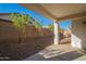 This backyard has a covered patio and desert landscaping, offering a private and low-maintenance outdoor space at 21120 E Creekside Dr, Queen Creek, AZ 85142