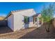 Backyard features desert landscaping, a covered patio, and privacy fencing, creating a tranquil outdoor retreat at 21120 E Creekside Dr, Queen Creek, AZ 85142