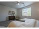 Tranquil bedroom featuring neutral colors, a ceiling fan, a window with blinds, and a comfortable bed at 21120 E Creekside Dr, Queen Creek, AZ 85142