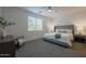 Cozy bedroom featuring a comfortable bed, natural light from a window, and a neutral color scheme at 21120 E Creekside Dr, Queen Creek, AZ 85142