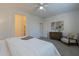 Serene bedroom with carpet flooring, featuring a comfortable bed and a minimalist design with a ceiling fan at 21120 E Creekside Dr, Queen Creek, AZ 85142