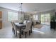 Bright dining area featuring a chandelier, a table with seating for six, and access to a patio with natural light at 21120 E Creekside Dr, Queen Creek, AZ 85142