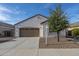 Charming single-story home featuring a well-maintained front yard and an attached two-car garage at 21120 E Creekside Dr, Queen Creek, AZ 85142