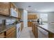 Well-equipped kitchen with wood cabinets, modern appliances, and a functional layout at 21120 E Creekside Dr, Queen Creek, AZ 85142