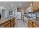 Spacious kitchen featuring a double sink, refrigerator, oven, and plentiful counter space at 21120 E Creekside Dr, Queen Creek, AZ 85142