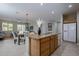 Bright open kitchen with island, seamlessly connects to the dining and living areas at 21120 E Creekside Dr, Queen Creek, AZ 85142