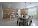 Open kitchen featuring wood cabinetry, tile floors, an island with seating, and stainless steel appliances at 21120 E Creekside Dr, Queen Creek, AZ 85142