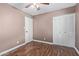Bedroom with hardwood floors, closet and ceiling fan at 2161 E Harmony Cir, Mesa, AZ 85204