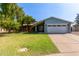 Charming single-story home with a well-maintained lawn, mature trees, and a two car garage at 2161 E Harmony Cir, Mesa, AZ 85204