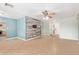 Spacious living room with tile flooring, custom accent wall, ceiling fan and open layout at 2161 E Harmony Cir, Mesa, AZ 85204