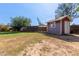 Backyard with a charming red shed, offering additional storage or workshop space on the property at 2161 E Harmony Cir, Mesa, AZ 85204