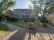 Manicured backyard with a lawn, mature trees, and a decorative planter at 22903 N 39Th Ter, Phoenix, AZ 85050