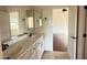 Bathroom featuring a double sink vanity with framed mirror and neutral colored walls at 22903 N 39Th Ter, Phoenix, AZ 85050