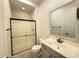 Bathroom featuring a framed glass shower enclosure, updated vanity, and modern fixtures at 22903 N 39Th Ter, Phoenix, AZ 85050
