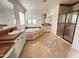 Well-lit bathroom with a soaking tub, walk-in shower, and dual vanities with ample counter space at 22903 N 39Th Ter, Phoenix, AZ 85050