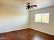 Bright bedroom with hardwood floors, a ceiling fan, and a large window offering plenty of natural light at 22903 N 39Th Ter, Phoenix, AZ 85050