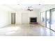 Spacious living room features a stone fireplace, tile flooring with design, and sliding glass doors to the patio at 22903 N 39Th Ter, Phoenix, AZ 85050