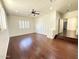 Spacious living room with a ceiling fan, plantation shutters, and hardwood floors at 22903 N 39Th Ter, Phoenix, AZ 85050