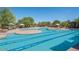 Community pool featuring lap lanes, sunning decks, covered seating areas and beautiful landscaping at 22903 N 39Th Ter, Phoenix, AZ 85050