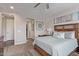 Comfortable bedroom with a wooden bed frame, modern decor, and an ensuite bathroom at 22920 E Indiana Ave, Queen Creek, AZ 85142