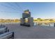 Lakeside outdoor fireplace with modern design, lounge seating, and string lights at 22920 E Indiana Ave, Queen Creek, AZ 85142