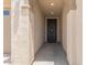 Inviting front entrance with stucco walls, lights, and a dark-colored door at 22920 E Indiana Ave, Queen Creek, AZ 85142