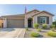 Inviting front exterior with tidy landscaping, a two-car garage, and a traditional design at 22920 E Indiana Ave, Queen Creek, AZ 85142
