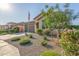 Well-maintained front yard with desert landscaping and a view of the charming home at 22920 E Indiana Ave, Queen Creek, AZ 85142