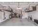 Spacious garage with overhead storage racks, providing plenty of room for parking and organization at 22920 E Indiana Ave, Queen Creek, AZ 85142