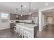 Open kitchen design with a large island, stainless steel appliances, and pendant lighting at 22920 E Indiana Ave, Queen Creek, AZ 85142