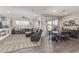 Spacious living room with a large sectional, tile flooring, and seamless access to the backyard at 22920 E Indiana Ave, Queen Creek, AZ 85142