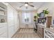 Well-lit home office with built-in storage, a desk, and a comfortable chair, perfect for remote work at 22920 E Indiana Ave, Queen Creek, AZ 85142