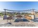 Community park with fire pit, seating, pergola and playground in the background at 22920 E Indiana Ave, Queen Creek, AZ 85142