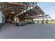 Community pavilion with metal roof, wood beams, outdoor seating, and lighting at 22920 E Indiana Ave, Queen Creek, AZ 85142