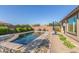 Beautiful backyard swimming pool area with pavers, lush plants, and outdoor seating at 22920 E Indiana Ave, Queen Creek, AZ 85142