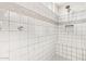 Bright tiled shower with a built-in bench and decorative tile accents at 22920 E Indiana Ave, Queen Creek, AZ 85142