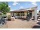 An expansive backyard features an extended covered patio with multiple areas for seating, dining, and entertaining at 26247 W Lone Cactus Dr, Buckeye, AZ 85396
