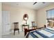 Bright bedroom featuring neutral walls, classic furniture, and a cozy quilt on the bed at 26247 W Lone Cactus Dr, Buckeye, AZ 85396