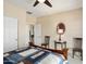 Bright bedroom featuring neutral walls, classic furniture, and a cozy quilt on the bed at 26247 W Lone Cactus Dr, Buckeye, AZ 85396