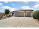 Charming single-story home with a three-car garage and meticulously maintained landscaping at 26247 W Lone Cactus Dr, Buckeye, AZ 85396