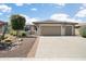 Inviting front yard with desert landscaping, a charming gate, and a well-maintained driveway at 26247 W Lone Cactus Dr, Buckeye, AZ 85396