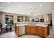 Bright kitchen with stainless steel appliances, granite countertops, and a seamless connection to the living area at 26247 W Lone Cactus Dr, Buckeye, AZ 85396