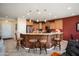 Modern kitchen with granite countertops, stainless steel appliances, and a breakfast bar at 26247 W Lone Cactus Dr, Buckeye, AZ 85396