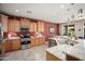 Well-equipped kitchen with wood cabinets, stainless steel appliances, and granite counters at 26247 W Lone Cactus Dr, Buckeye, AZ 85396