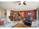 Open-concept living room features a kitchen bar, cozy seating, and lots of natural light at 26247 W Lone Cactus Dr, Buckeye, AZ 85396