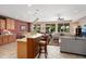 Open-concept living space with a kitchen island, comfortable seating, and lots of natural light at 26247 W Lone Cactus Dr, Buckeye, AZ 85396